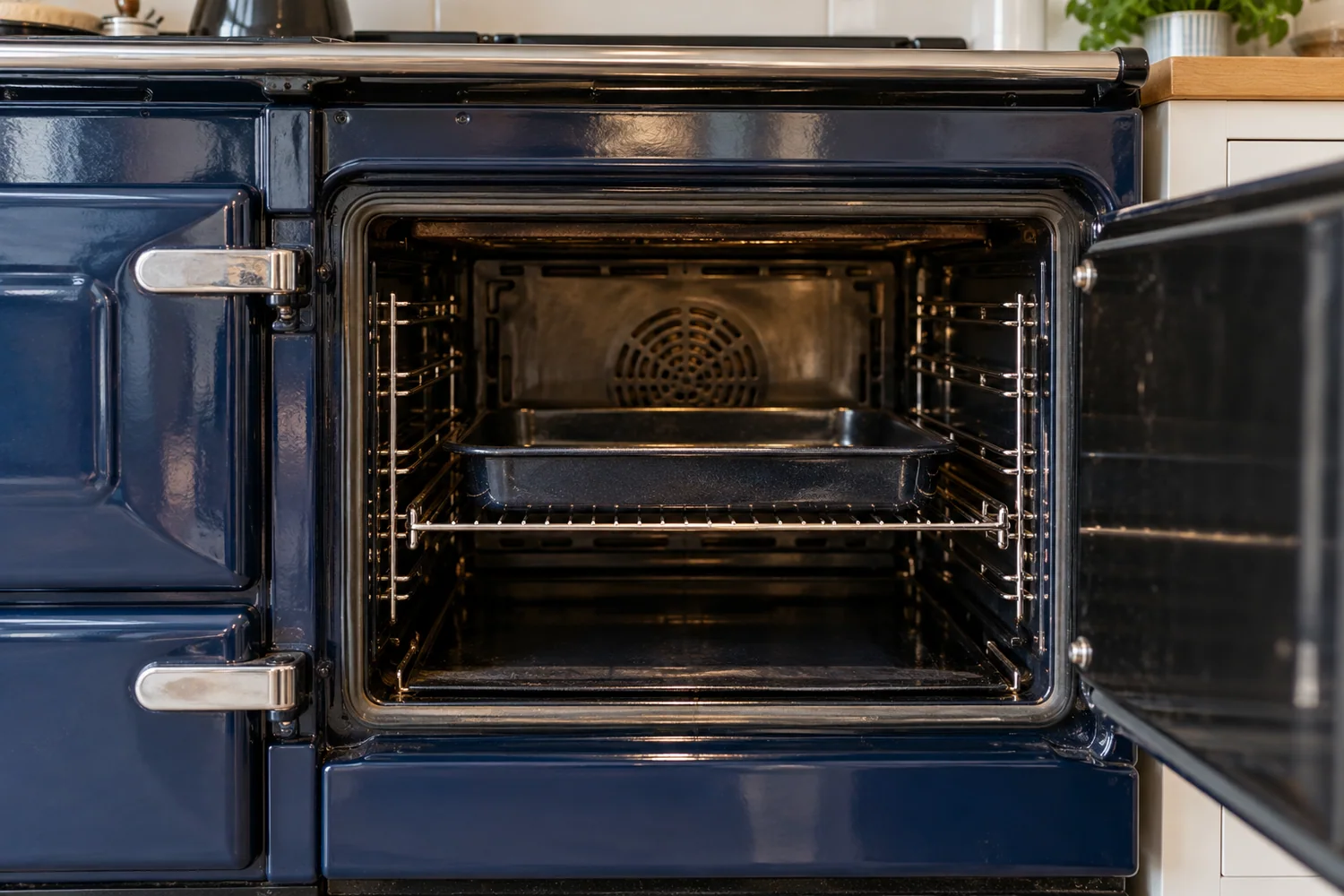 Open range cooker compartment with a rack and enamel tray